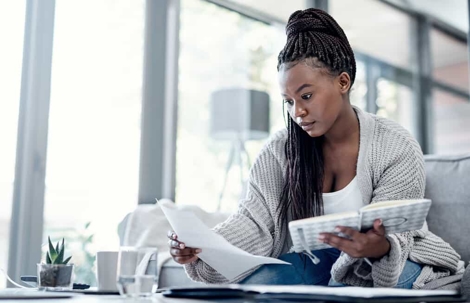 Young woman goes over documents in a brightly lit room